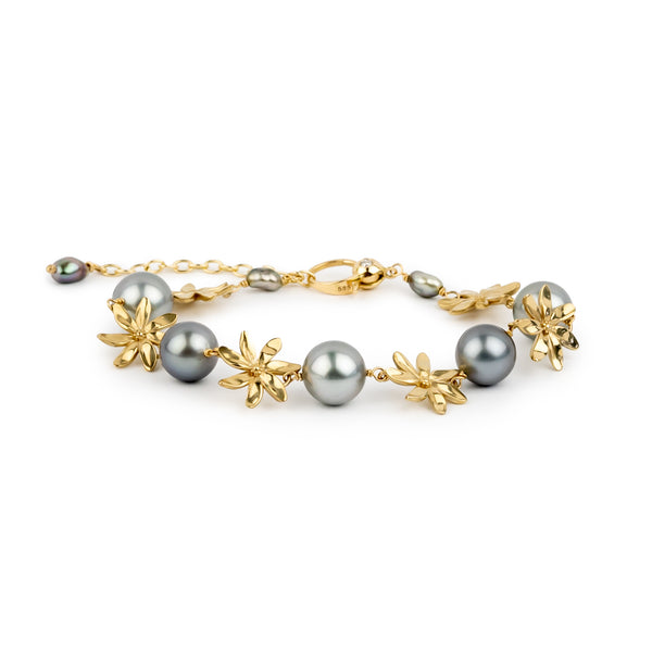 Gold bracelet with gray pearls on a white background